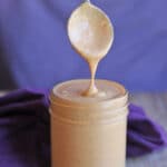 Text overlay: Simple peanut sauce for spring rolls, satay, and bowls. Spoon dripping sauce into jar.