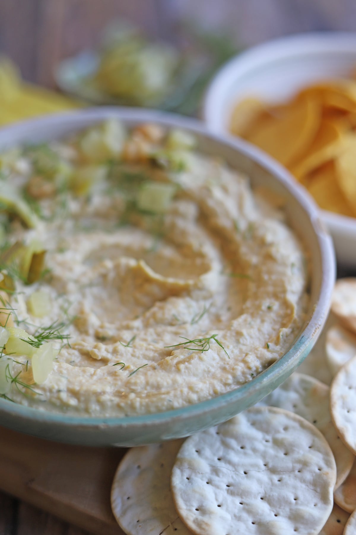 Close-up dill pickle hummus in bowl.
