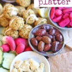 Text overlay: Falafel platter. Olives and veggies on platter with falafel.