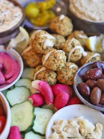 Radishes and falafel on grazing board.