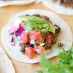 Taco with lentil taco meat on platter.