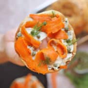 Vegan smoked salmon (carrot lox) on bagel with vegan cream cheese, capers, and dill.