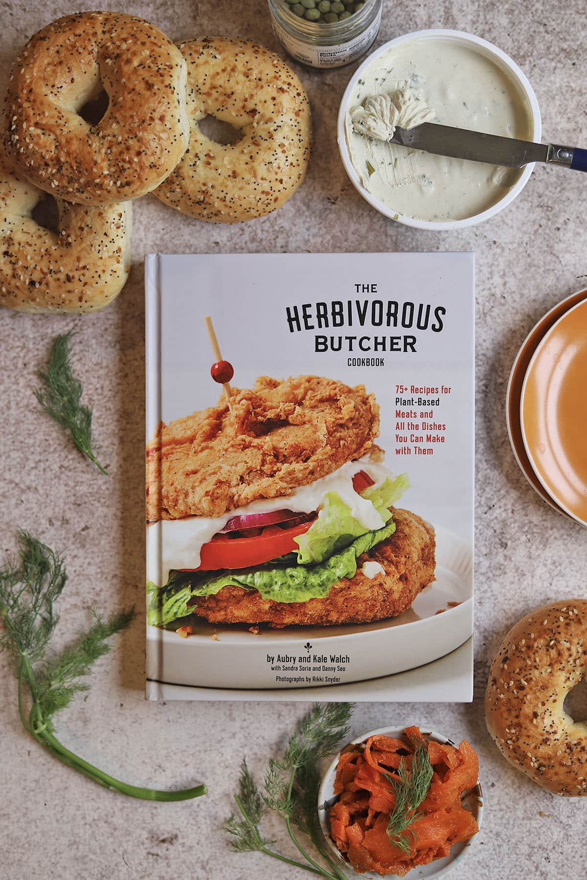 Herbivorous Butcher cookbook with bagels, vegan cream cheese, and carrot lox.