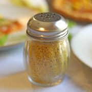 Homemade vegan parmesan cheese in sprinkle jar.