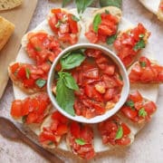 Tomato bruschetta crostini on platter.