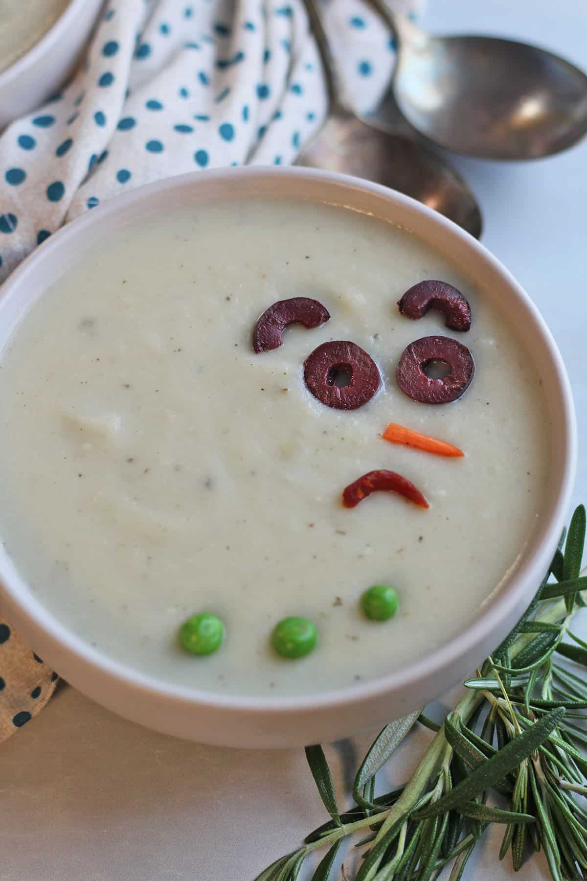 Sad snowman face on bowl of dairy-free potato soup.