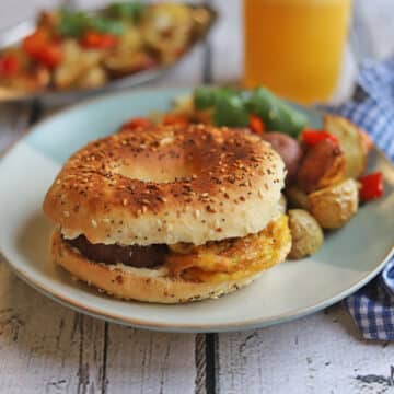 Vegan breakfast sandwich on plate with potato hash.