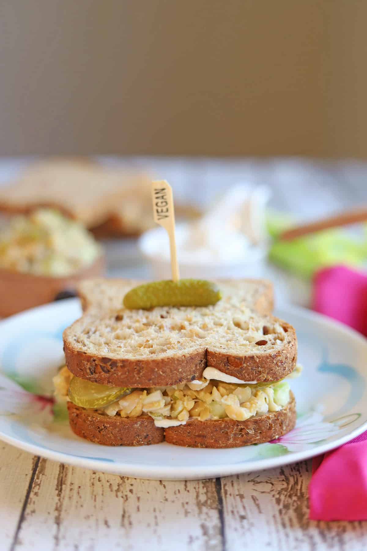 Chickpea salad on bread with vegan mayo and pickle.