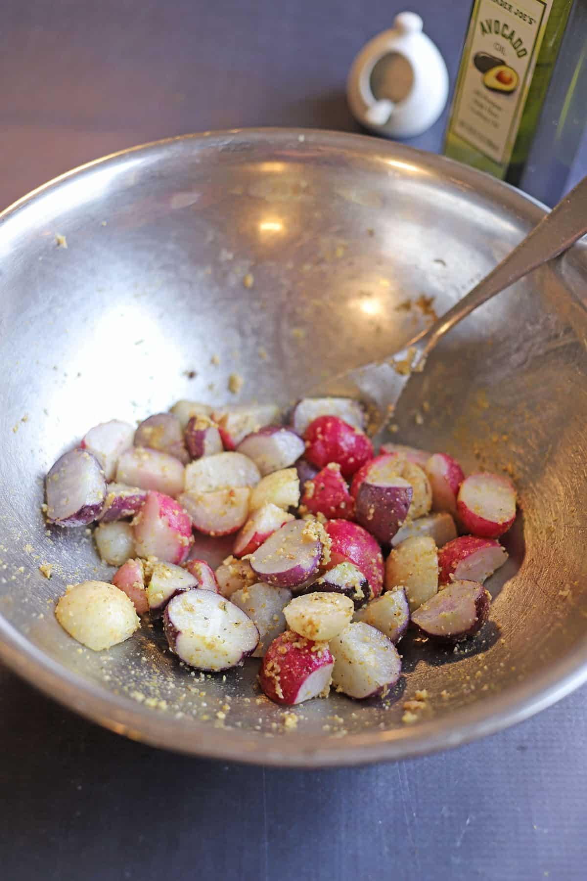 Air fryer radishes in bowl with vegan parmesan.