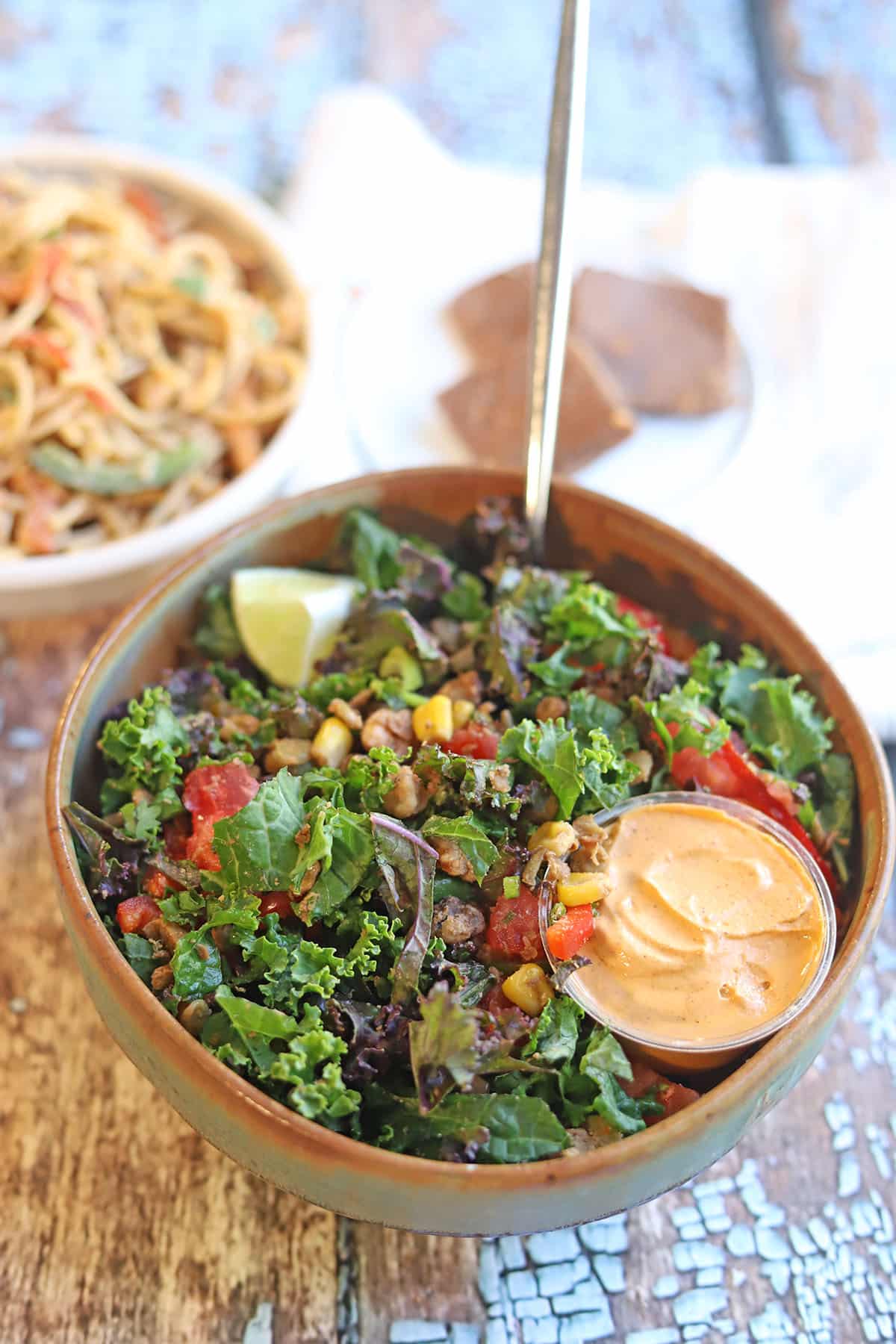 Kale salad in a bowl with cumin dressing.