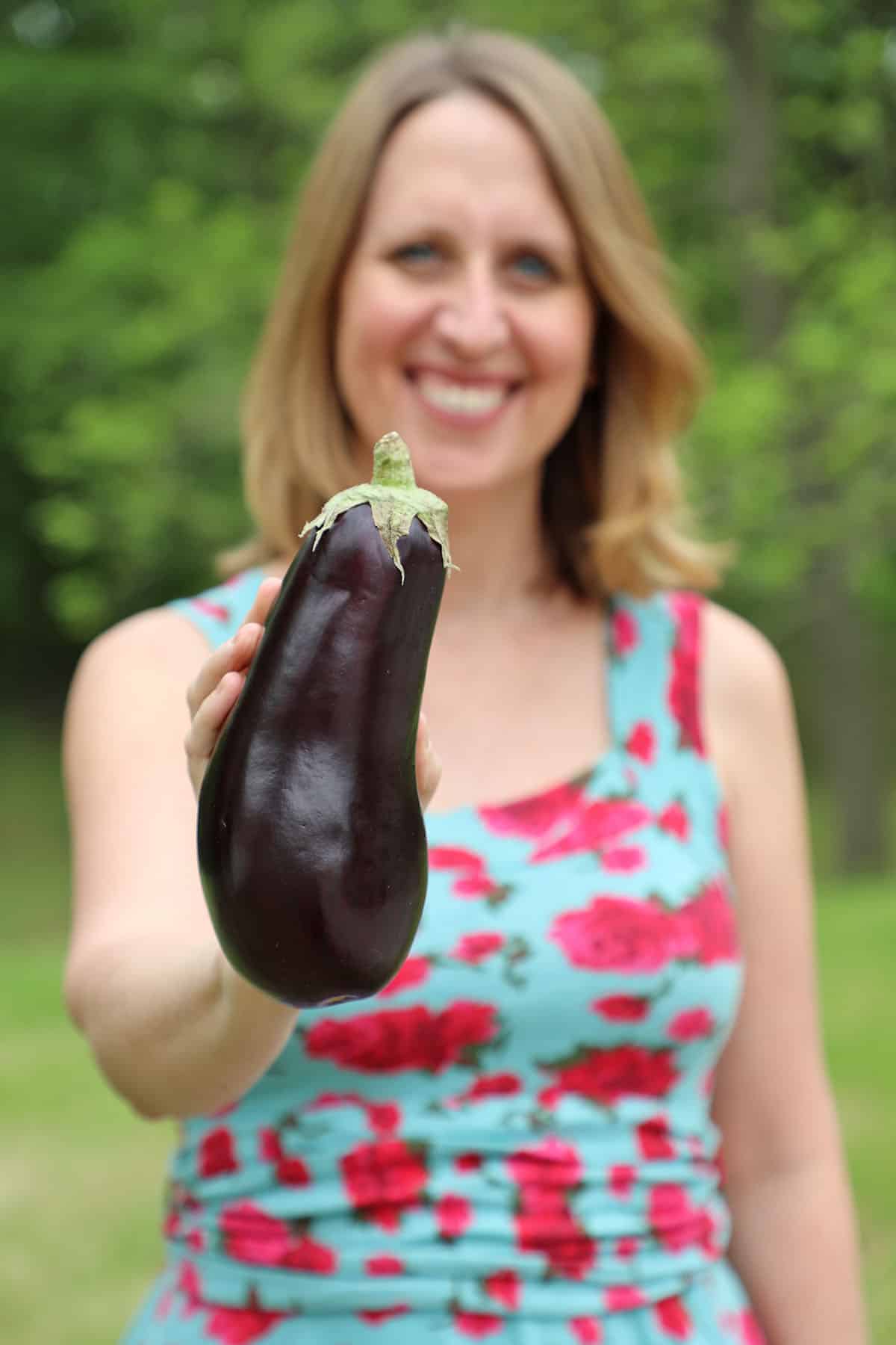 Cadry holding eggplant.