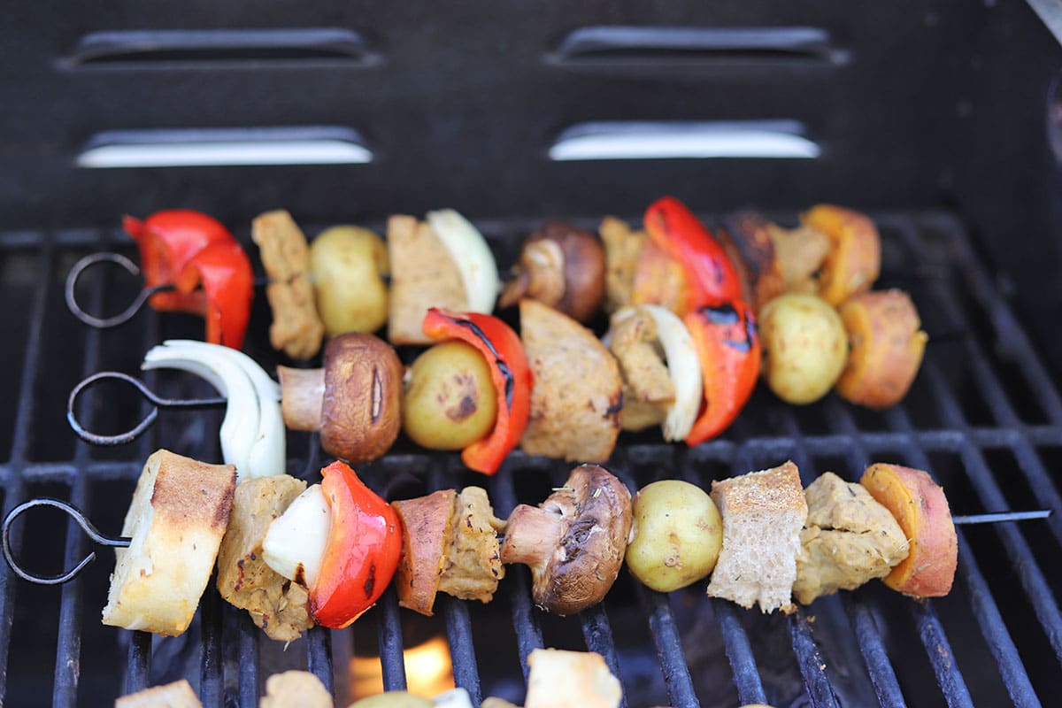Vegan kebabs being grilled outdoors.