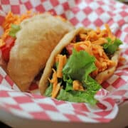 Vegan puffy tacos in checkered basket.