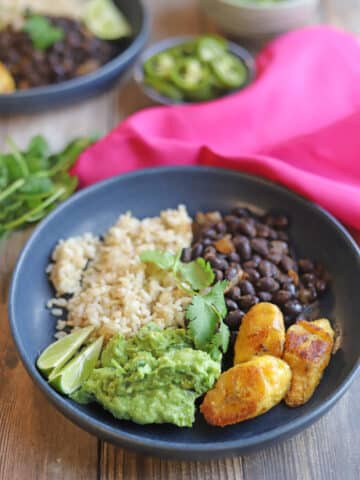 Black bean bowl with guacamole, rice, and fried plantains.