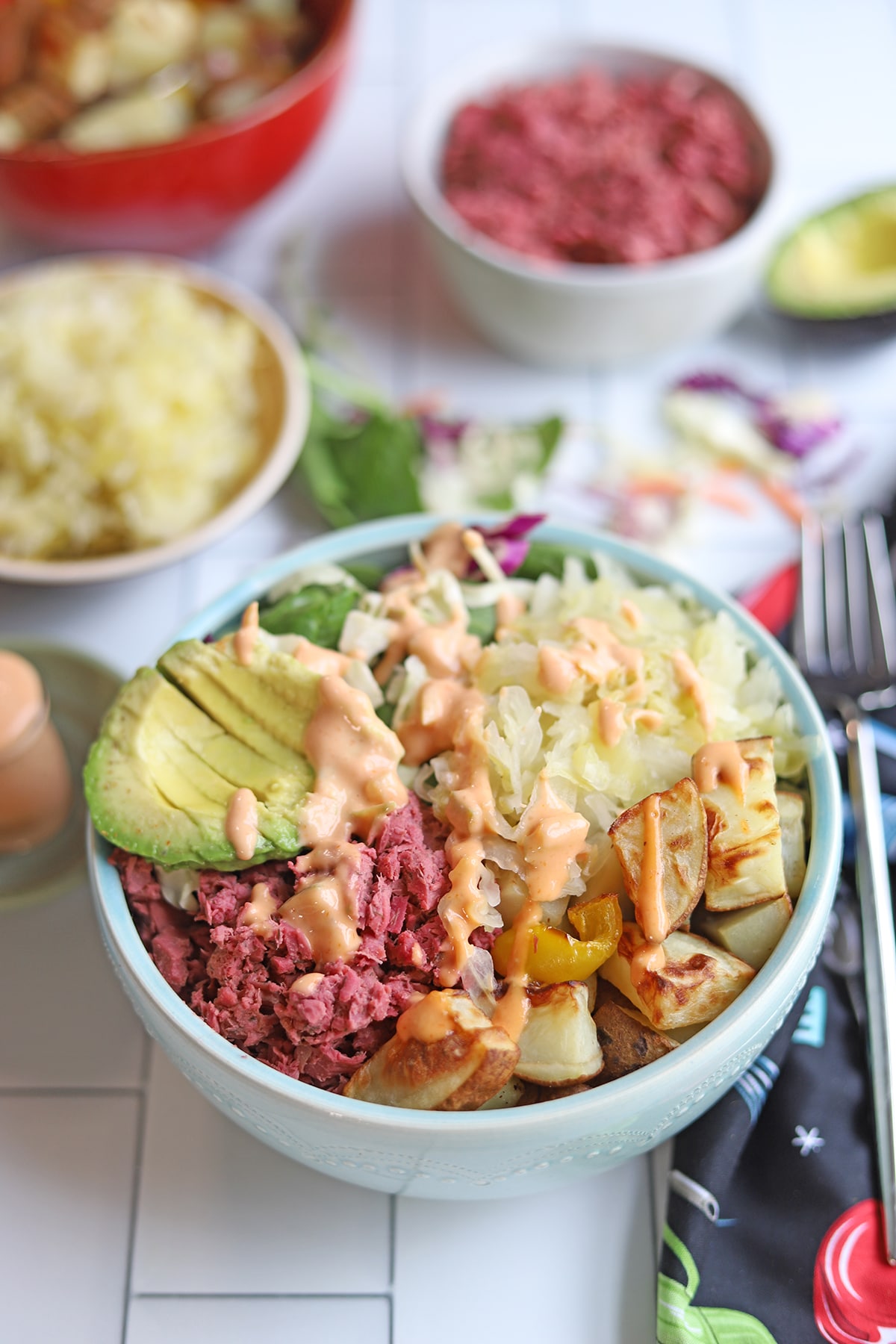 Nourish bowl with avocado, corned jackfruit, sauerkraut, and potatoes.