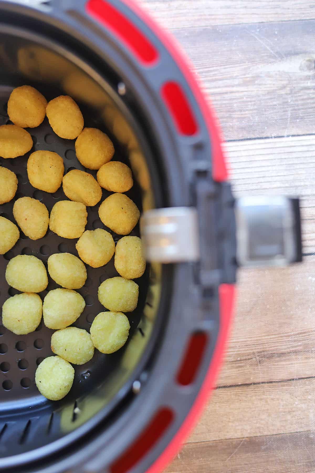 Gnocchi in air fryer basket.