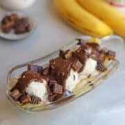 Dairy-free banana split with ice cream and chocolate sauce.