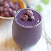 Blueberry banana smoothie in glass.