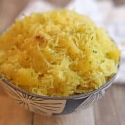 Air fried spaghetti squash in blue and white bowl, seasoned with onion and garlic salt.