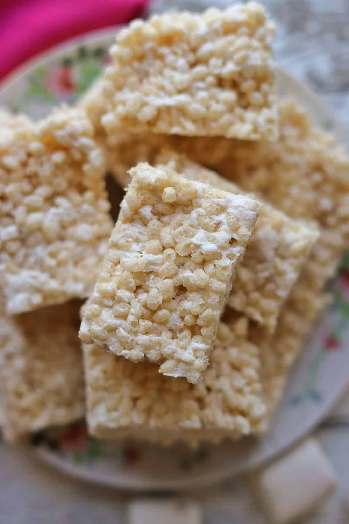 Close-up melted marshmallows in vegan rice crispy treats on platter.