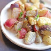 Colorful air fryer radishes on white plate.