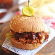 Barbecue jackfruit sandwich speared with pepperoncini.