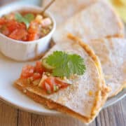 Dairy-free refried bean quesadillas with salsa on plate.