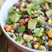 Black bean corn avocado salad in bowl with cilantro.