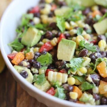 Black bean corn avocado salad in bowl with cilantro.