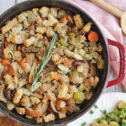 Vegan stuffing with chestnuts, carrots, and celery in Dutch oven.