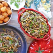 French lentils with caramelized onions and pistachios in serving dish.