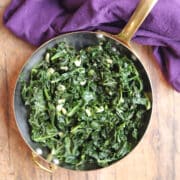Sauteed kale with garlic in gold pan.