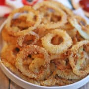 Crispy egg-free air fried onion rings on platter.