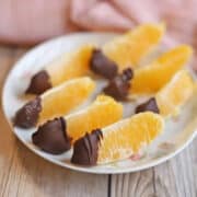 Plate with chocolate covered orange slices.