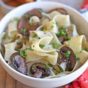 Bowl of vegan butter noodles with red wine mushrooms & chives.