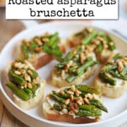 Text overlay: cadryskitchen.com, roasted asparagus bruschetta. Vegan asparagus appetizer on platter.