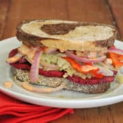 Seitan reuben on marbled rye with peppers and onions.