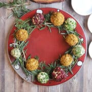 Vegan cheeseball wreath with tofu cheese and fresh herbs.