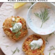 Text overlay: Vegan crab cakes with lemon dill aioli. Two artichoke chickpea crab cakes on plate with lemon dil aioli serving sauce.
