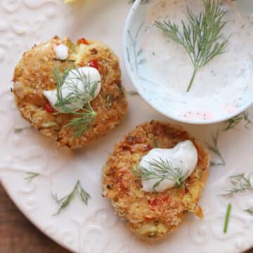 Chickpea crab cakes on plate with lemon dill aioli serving sauce.