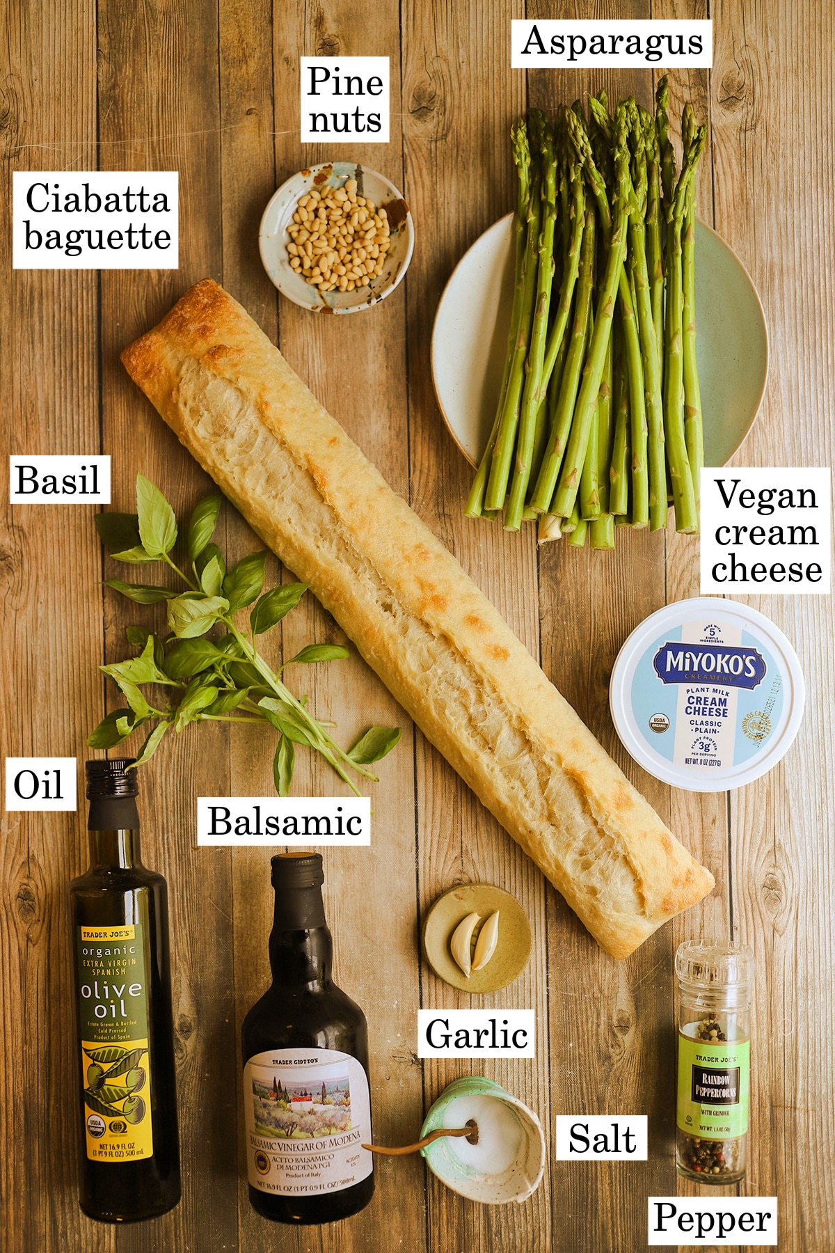 Labeled ingredients for roasted asparagus bruschetta on table.