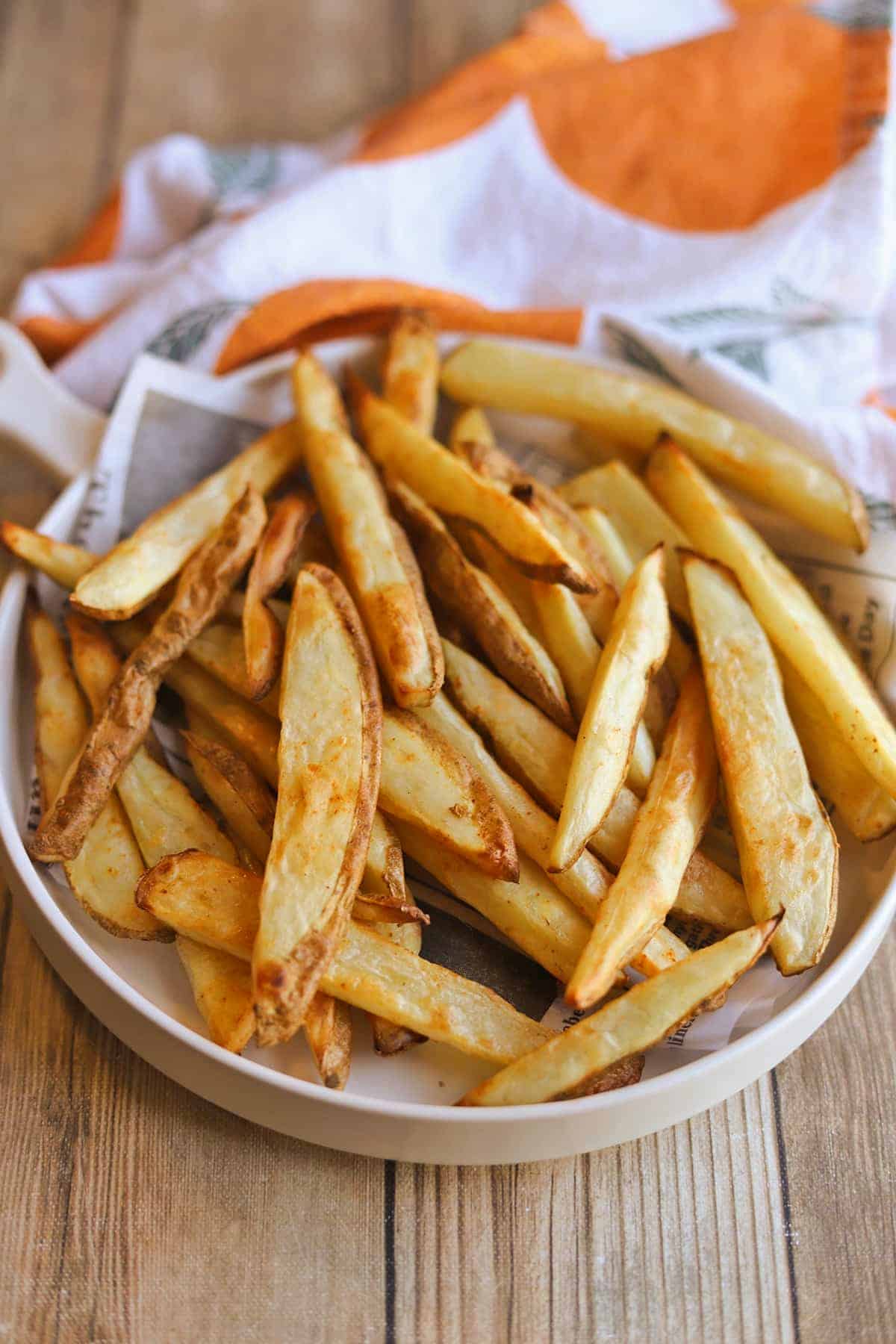 Baked fries on platter by towel.