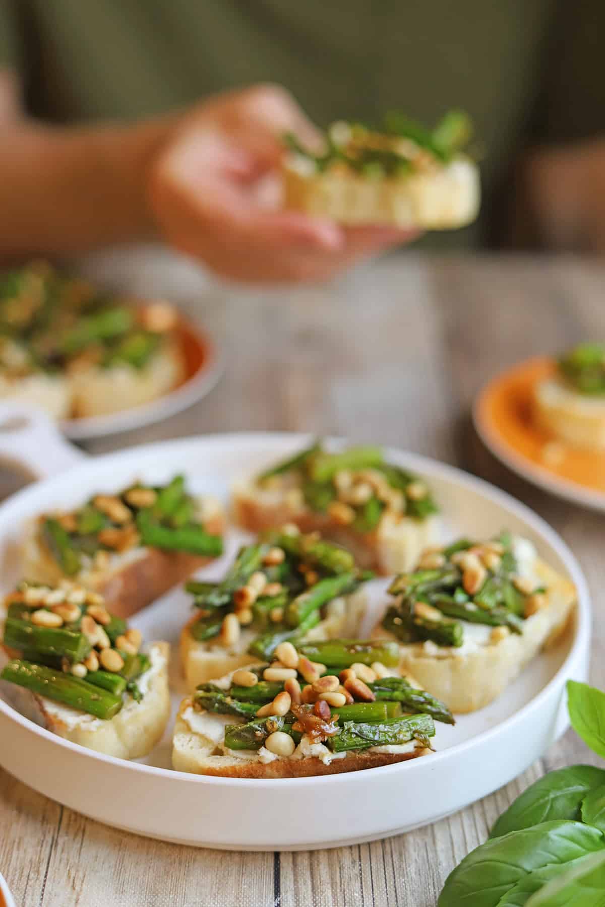 Roasted asparagus bruschetta platter with toasted pine nuts.