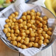 Roasted chickpeas coated in nutritional yeast and salt in pan.