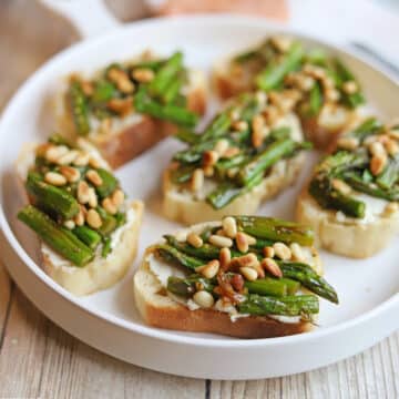 Roasted asparagus with toasted pine nuts on vegan cream cheese & toasted baguette.