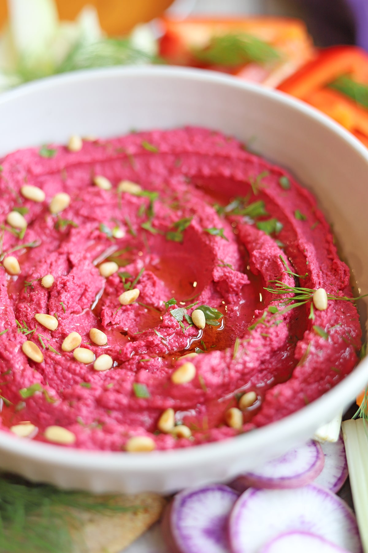 Extra virgin olive oil drizzled on air fryer hummus with toasted pine nuts and dill.