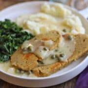 Seitan with lemon caper sauce by kale and mashed potatoes.