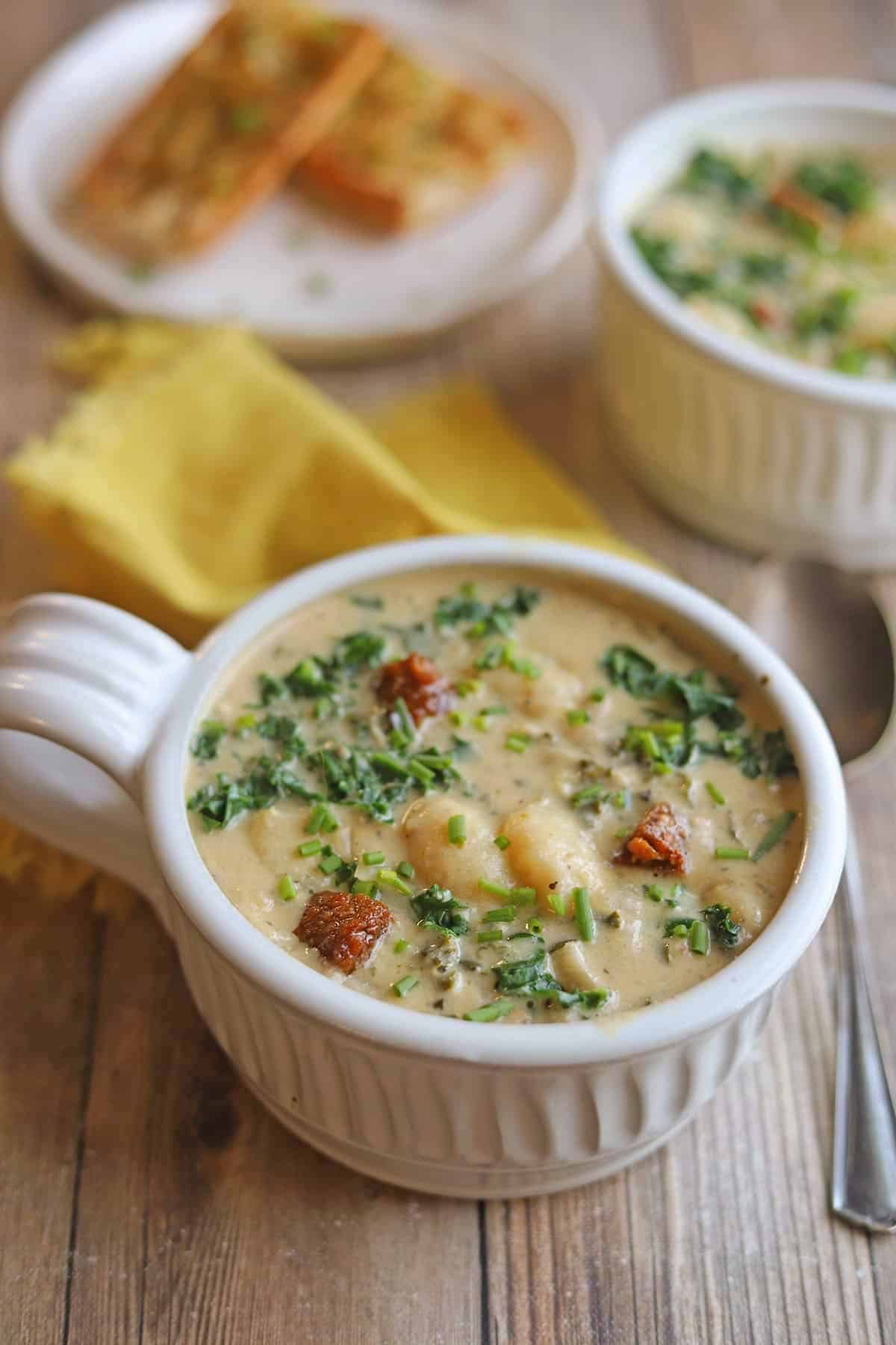 Dairy-free gnocchi soup with cashew cream, kale, and vegan sausage.