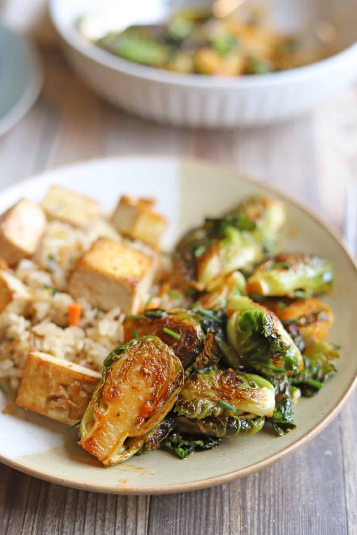 Gochujang Brussels sprouts on plate with rice and tofu.