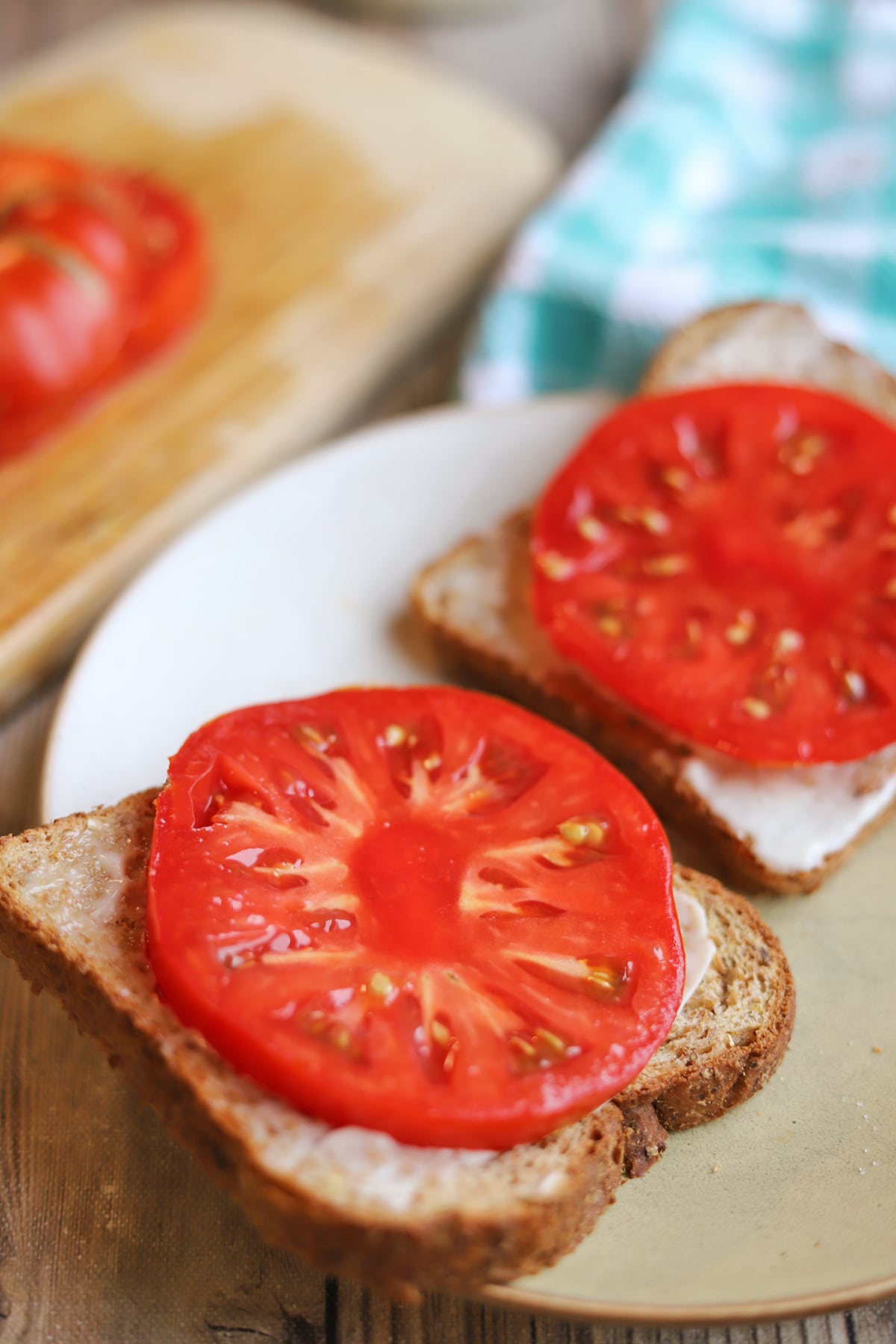 Summer tomato sandwich with slathering of vegan mayo.
